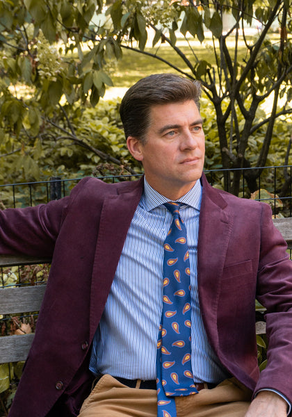 Model sitting on bench in Burgundy Corduroy Sportcoat